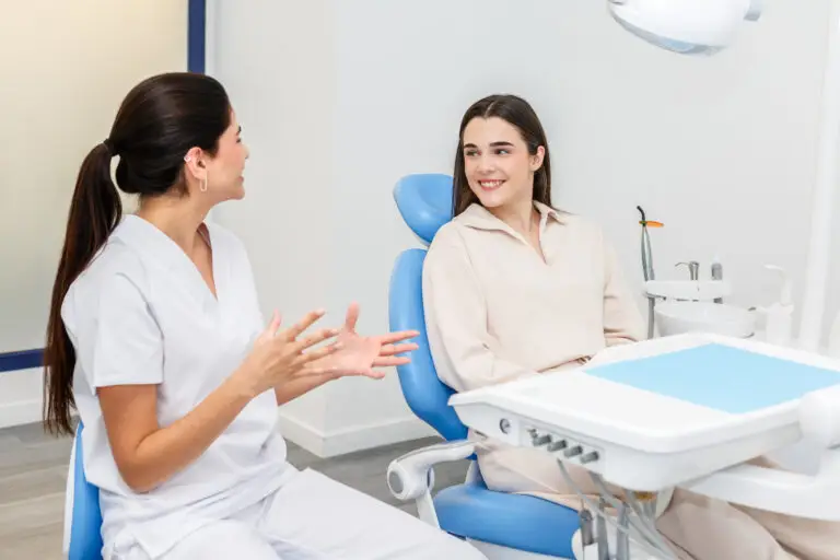 dentist talking to patient about dental savings plans and consultation